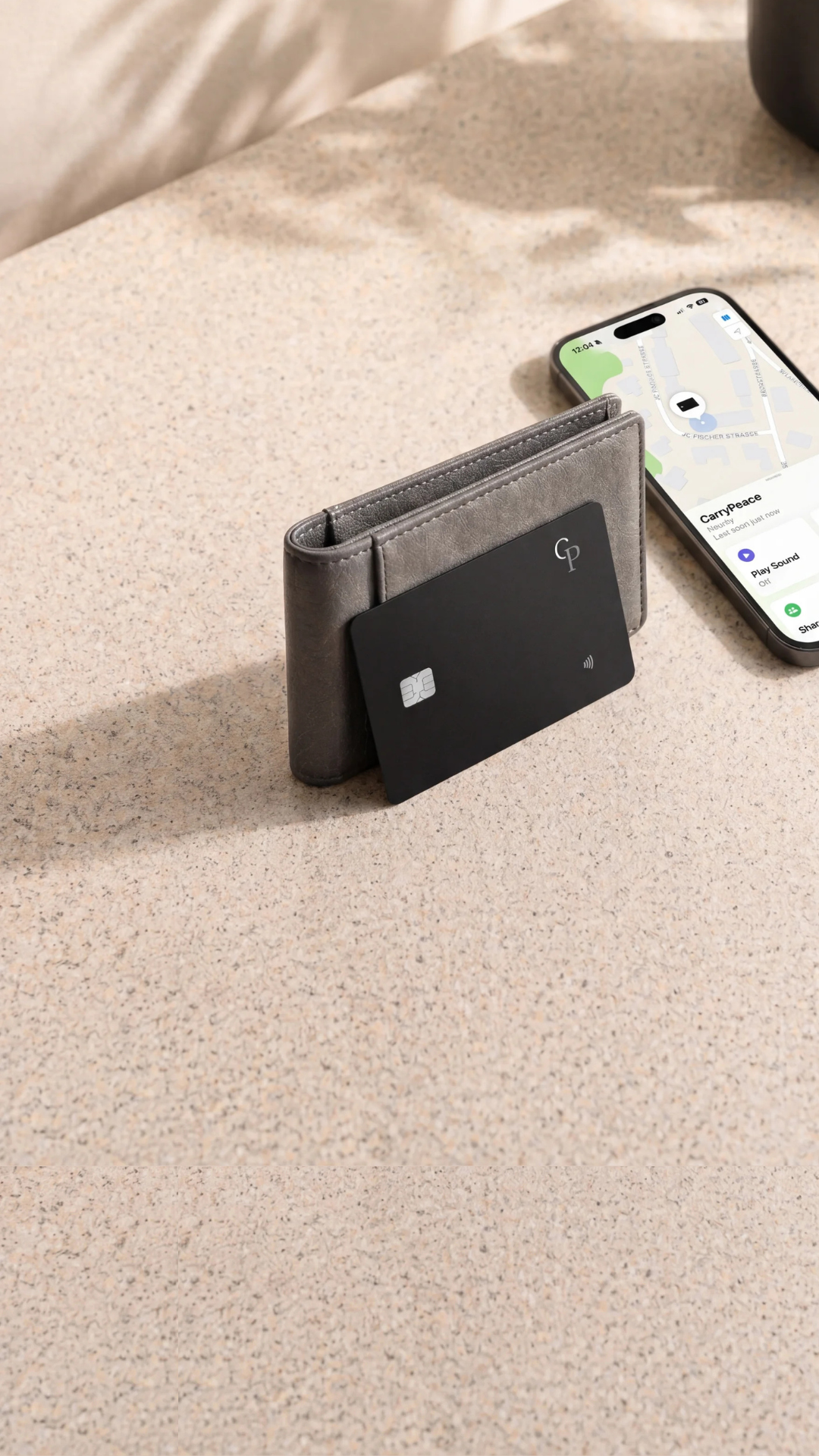 CarryPeace slim wallet tracker card next to a wallet and iPhone using Apple Find My to locate a lost wallet and play a nearby sound.